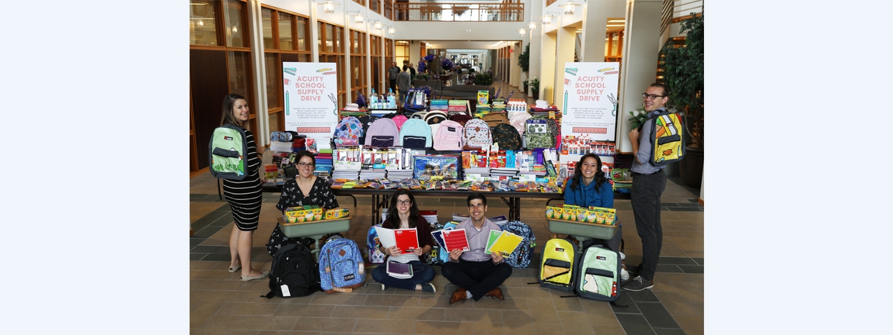 Members of the Acuity Employee Activity Committee are pictured with the record contributions made by employees during Acuity’s annual school supply drive.