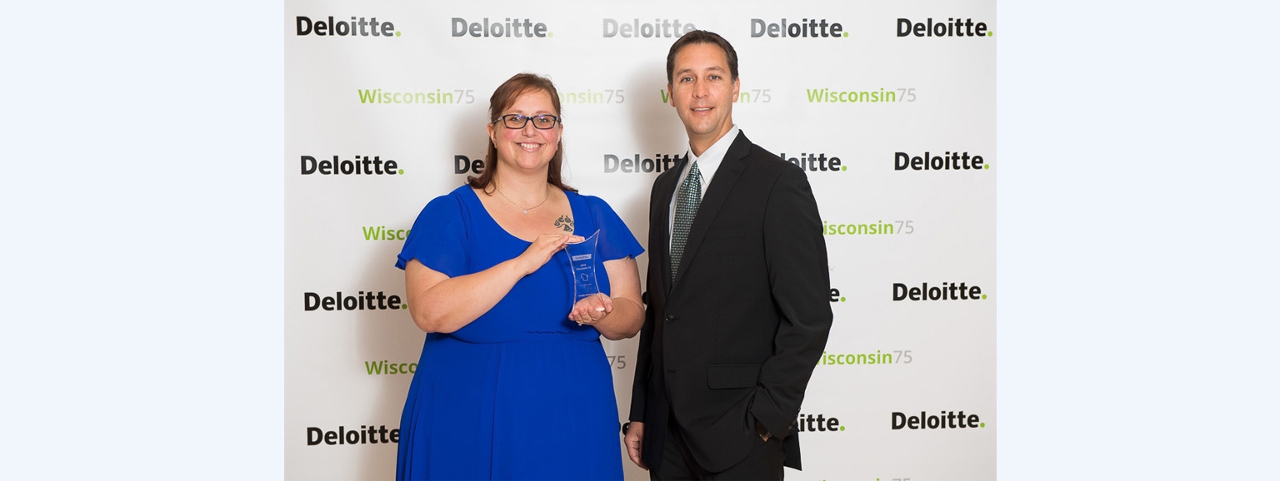 Senior Business Analyst Amanda Radloff and Paul Miller, Manager - Communications, receive the Deloitte Wisconsin 75 award on behalf of Acuity.