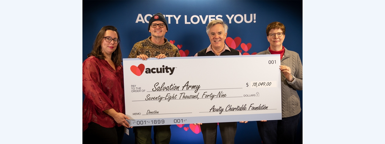 Salvation Army: CJ Cony, Development Director, and Captain Daryl Mangeri of the Salvation Army - Sheboygan accept a check for over $78,000 from Acuity President and CEO Ben Salzmann and Wendy Schuler, Vice President - Finance.