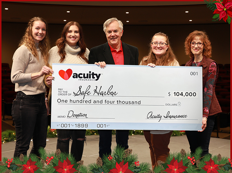 Safe Harbor: Acuity’s Sheri Murphy and Ben Salzmann present a check for $104,000 to Safe Harbor’s Britta West, Courtney Stewart, and Vanessa VanderWeele.