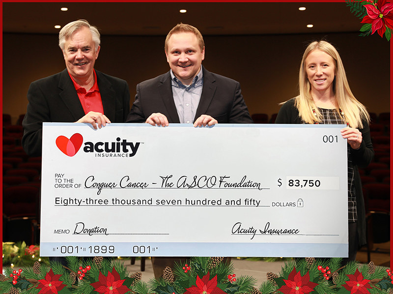 Dave Wiemer from Conquer Cancer, the ASCO Foundation, accepts a check for nearly $84,000 from Acuity’s Alissa Burgos and Ben Salzmann.