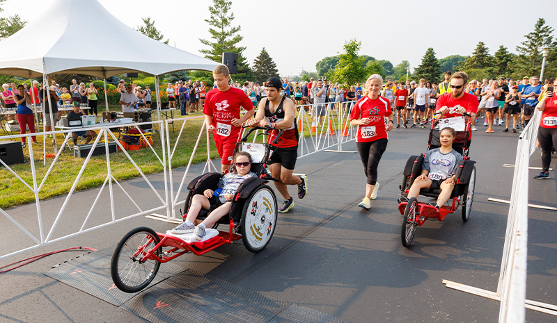 myTEAM TRIUMPH Captains George Phillips and Tim Muldoon with Megan (left team) and Captains Therese Gries and Brandon Schulz with Sonya. (Photo from Jeff Kernen Photography)