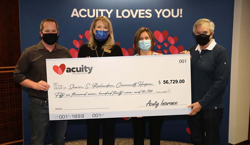 Lee Mitchler and Charmaine Conrad from Sharon S. Richardson Community Hospice accept a check for nearly $57,000 from Acuity’s Shane Paltzer and Ben Salzmann.