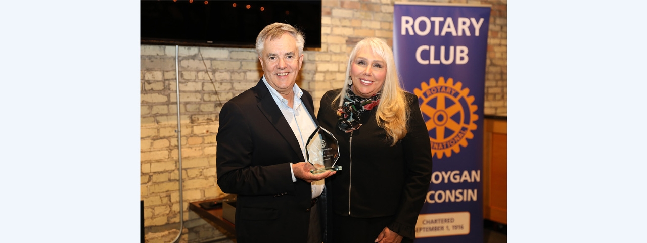 Allyson Olivier presents the Sheboygan Rotary Club’s Good Citizen of the Year Award to Acuity’s Ben Salzmann.