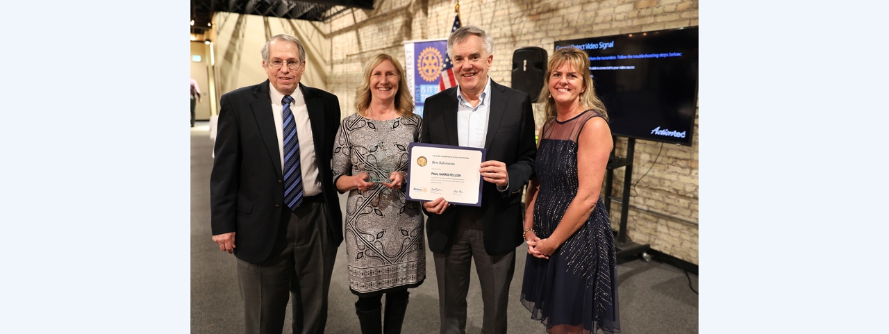 Rotarians Steve McClean, Deborah Wente, and Mary Pitsch present the Paul Harris Fellow recognition to Acuity’s Ben Salzmann.