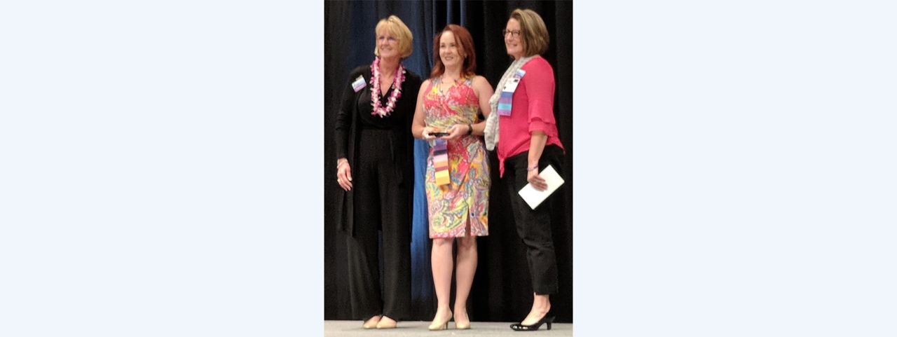 Keri Herlong receives the Insurance Professional of the Year Award and the Professional Underwriter of the Year Award from IAIP International President Angie Sullivan (left) and Region IV Vice President Penny Duer.